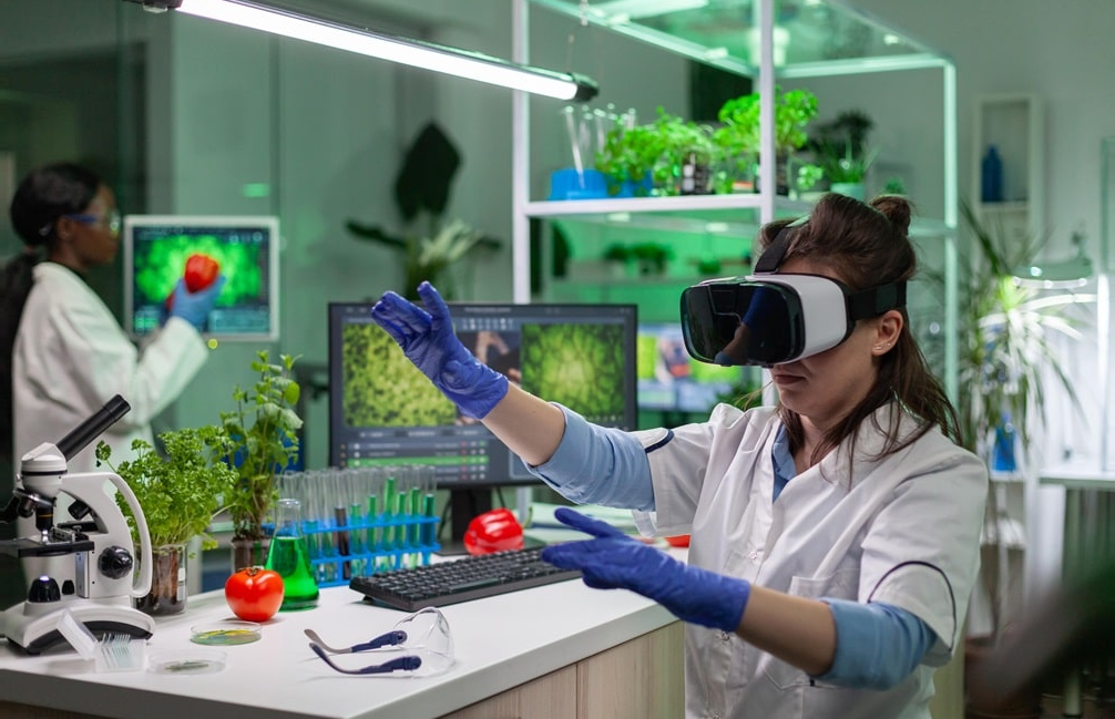 Student in a VR headset exploring a virtual biology lab, with plant samples and microscope imagery around her